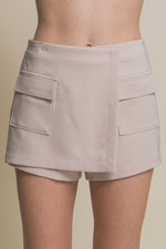 Stylish women's skorts with cargo pockets, featuring a neutral beige tone and a sleek, modern design.