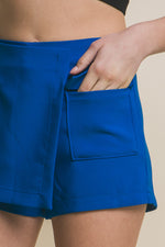 Vibrant blue womens skorts with functional cargo pockets, featuring a stylish and versatile design for active lifestyles.