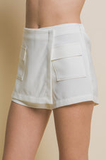 Stylish white cargo skorts with functional pockets, perfect for casual or athleisure wear.