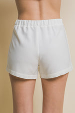 Comfortable white women's skorts with functional cargo pockets, showcasing a stylish and practical design.