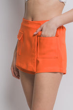 Vibrant orange skorts with functional cargo pockets, ideal for Cecelia's athletic and stylish collection.