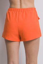 Vibrant orange women's skorts with cargo pockets, showcasing a stylish and functional design from the CCWHOLESALECLOTHING brand.