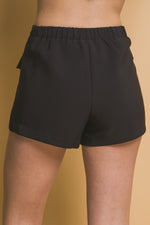 Versatile black women's skorts with cargo pockets from CCWHOLESALECLOTHING brand, featuring a comfortable elastic waistband for a relaxed fit.