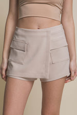 Stylish beige skorts with functional cargo pockets, perfect for a fashionable and practical look.