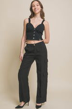 Stylish full-length Tencel pants with cargo pockets, worn by a smiling model.