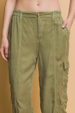 Olive green cargo pants with multiple pockets, displayed on a model's lower body against a plain background.