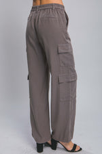 Comfortable and versatile cargo pants with multiple pockets in a neutral gray color, suitable for casual or active wear.