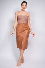 Faux Leather High-rise Cargo Skirt by CCWHOLESALECLOTHING, featuring a chic, sophisticated model wearing the fashionable brown leather midi skirt.