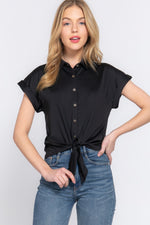 Stylish short-sleeved stretch knit top with front tie detail, worn by a young blonde woman with red lipstick against a plain background.