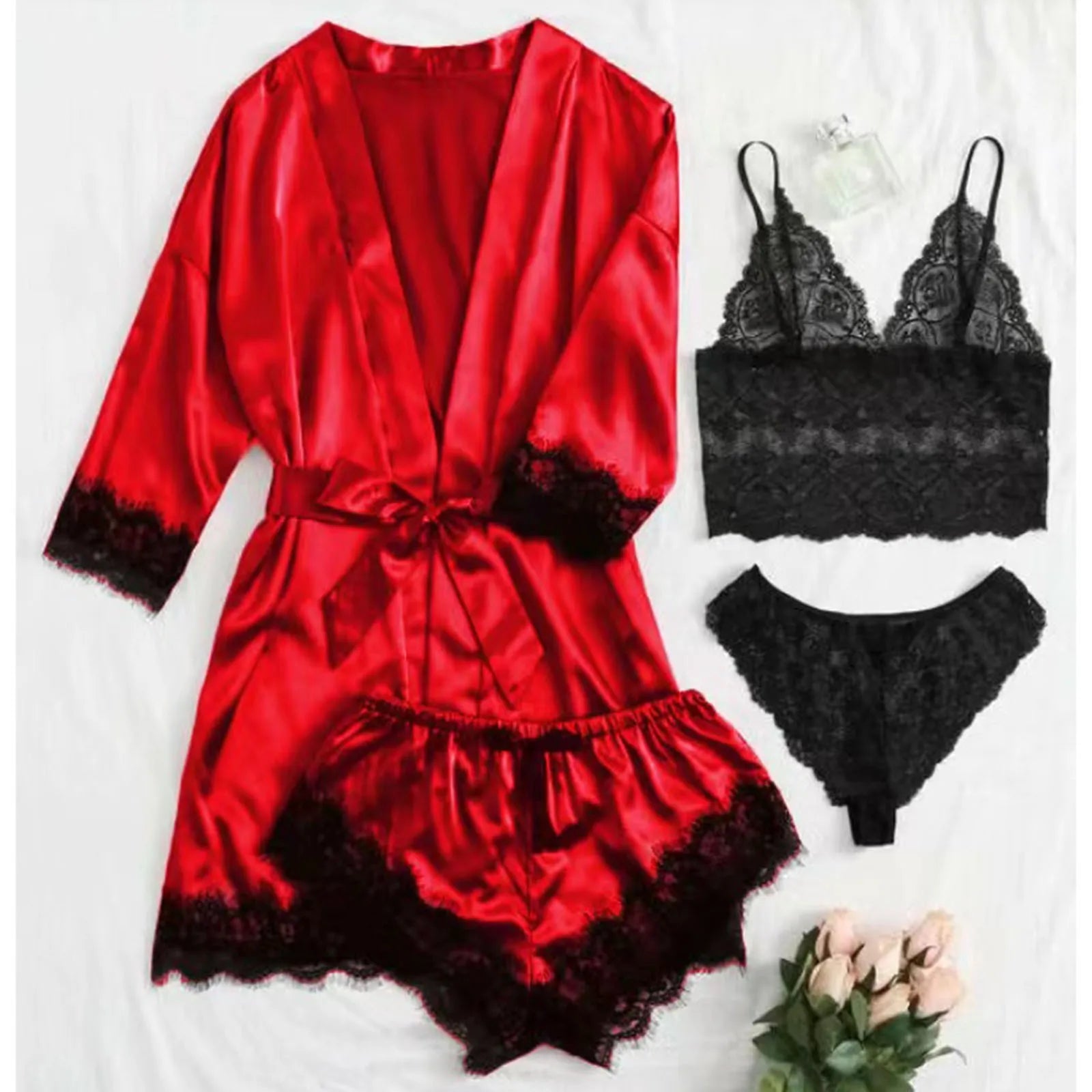 4-piece luxurious silk lingerie set with long red robe, lace trim, and matching black bralette and panties displayed on a white background with a bouquet of flowers.
