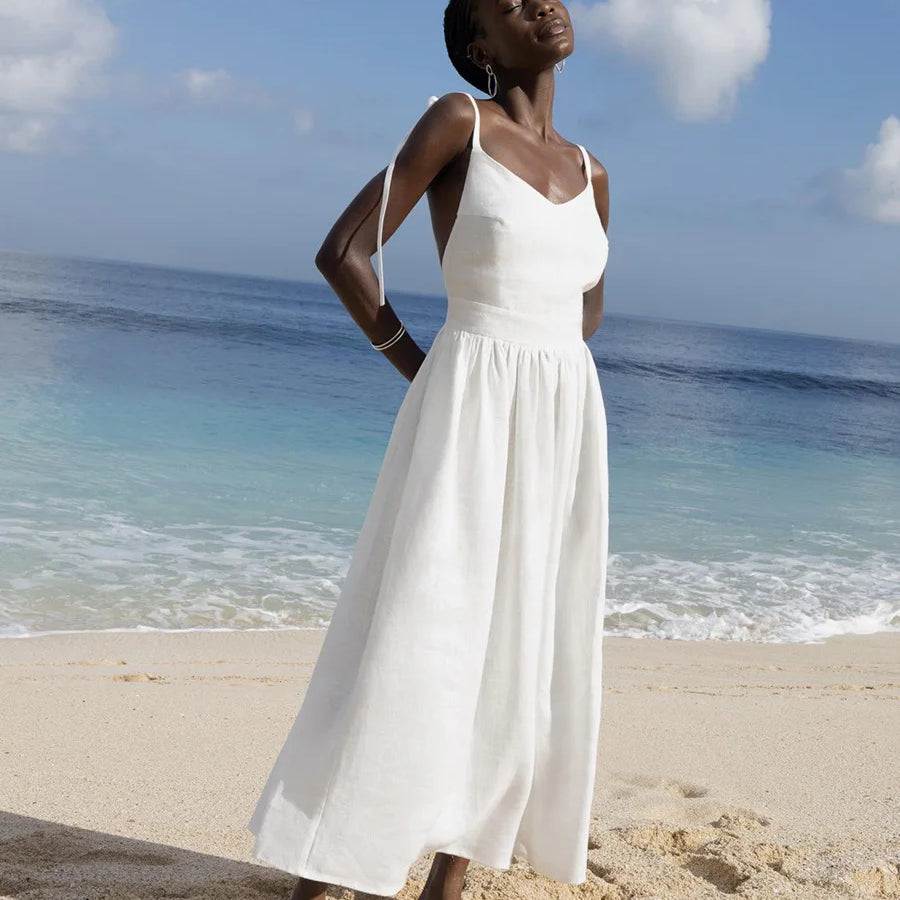 Elegant white beach dress with flowing A-line silhouette, perfect for a seaside vacation.